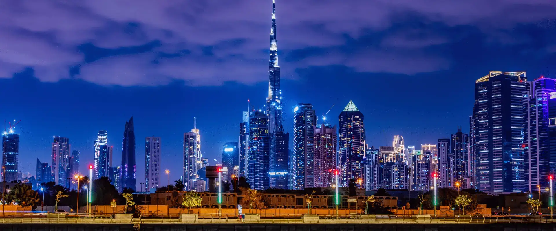 Dubai skyline at night with Downtown towers lit up under a purple sky